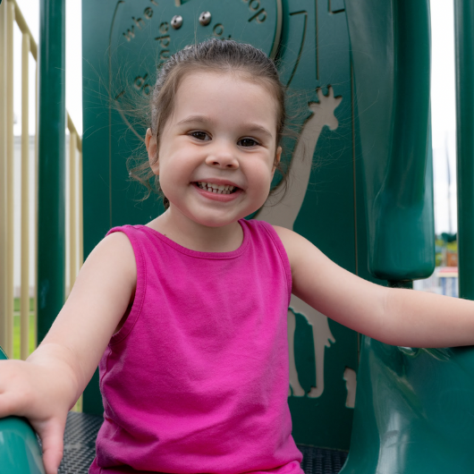 3-year old Audrina Sorbera smiles at her doctor as her mother holds her