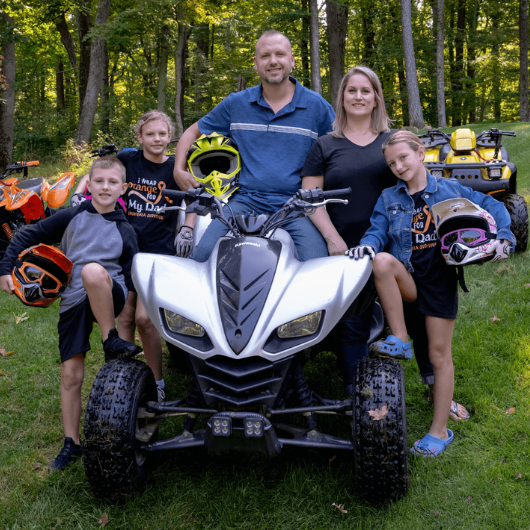 Adam Gourlay, of Fredon, New Jersey, stands next to his four-wheeler with his wife and three kids.