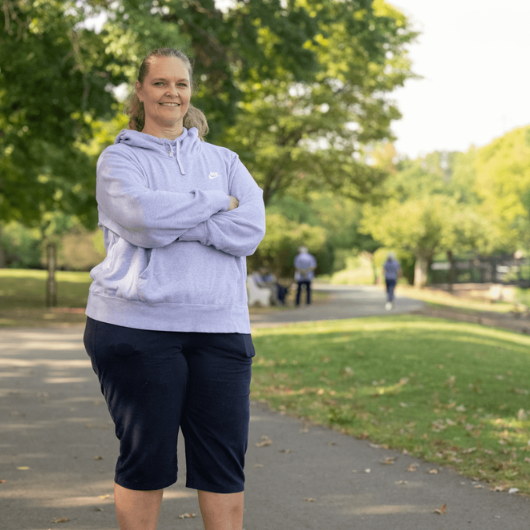 Linda Hayes of Somerville, New Jersey, stands in a park outside with her arms folded.