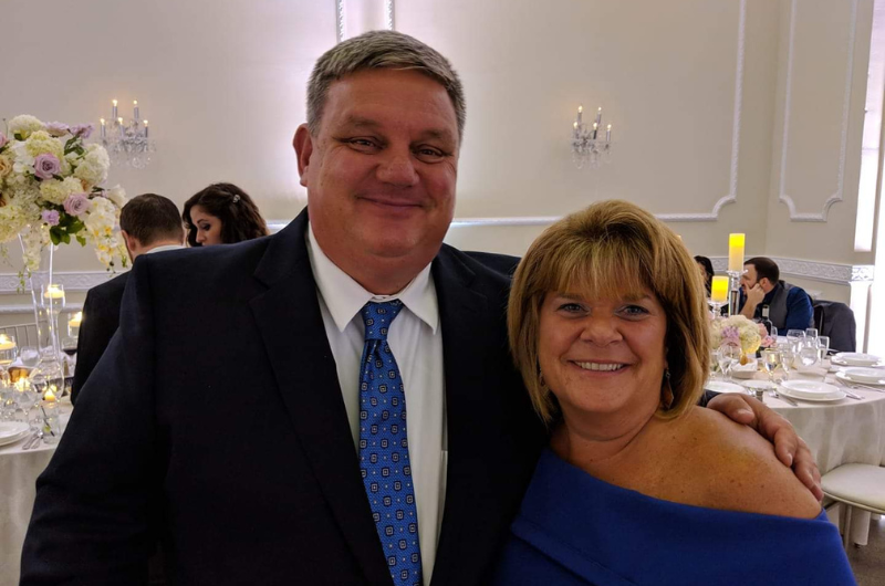 Graham Mulholland, of Belmar, New Jersey, smiles while standing next to his wife.