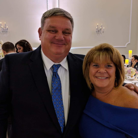 Graham Mulholland, of Belmar, New Jersey, smiles while standing next to his wife.
