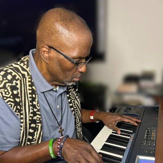 Troy Randall , a 61-year-old Smyrna, Delaware resident, sits and plays music on a keyboard.