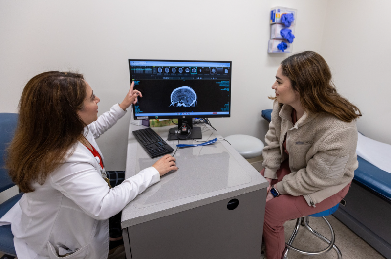 Lauren Trachtenberg, M.D., looks at an image of the brain with Christine Greiss, D.O.   