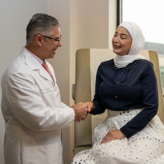46-year-old Rania Targali shakes hands with her doctor, Michael J. Goldstein, M.D., FACS.