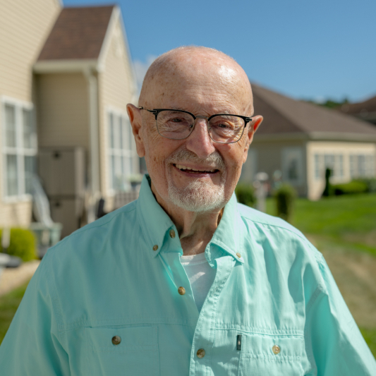 Nick smiling outside his home.