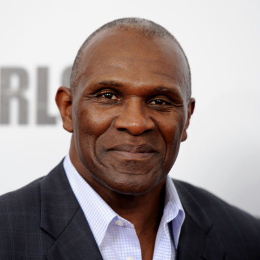 A close-up shot of Harry Carson looking at the camera with a closed-mouth smile.