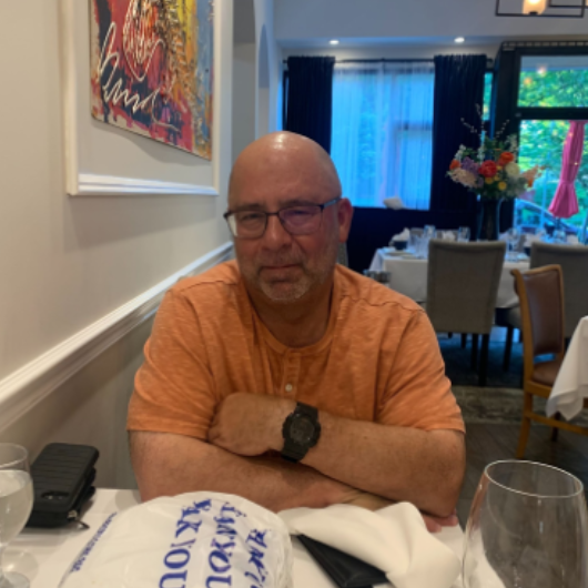 John Frotton, a 66-year-old chemical engineer from East Stroudsburg, Pennsylvania, sits at a restaurant dining table.