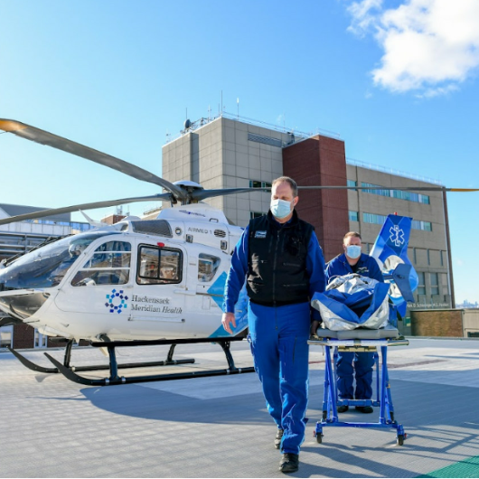 A patient is transported from Hackensack Meridian Health's AirMed One helicopter. 