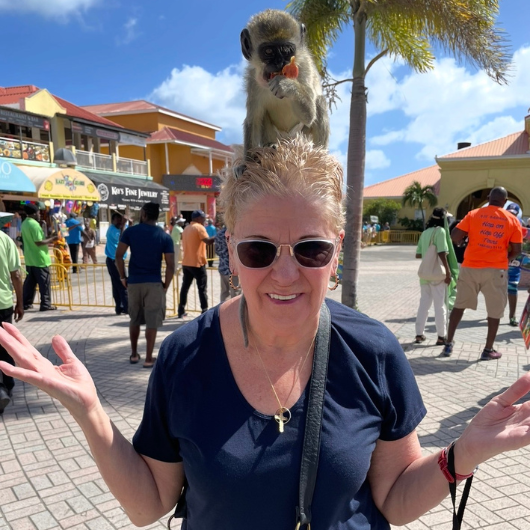 While on a vacation, Loisanne Diehl poses with a monkey on her head.