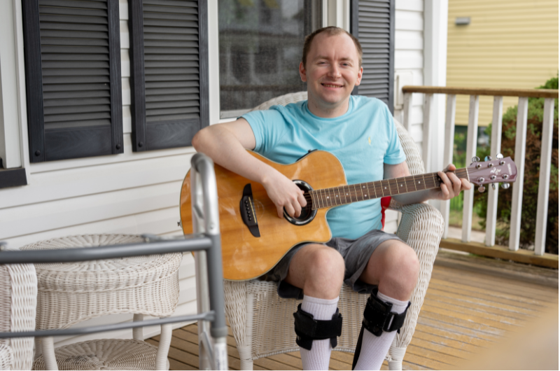 Jack Mehr sits on his porch in Milltown, New Jersey, confidently strumming his guitar.