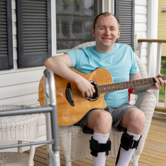 Jack Mehr sits on his porch in Milltown, New Jersey, confidently strumming his guitar.