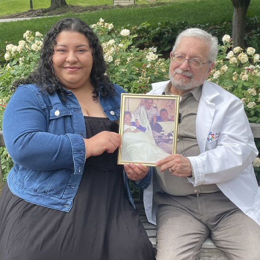 Lanay Lopez holds a framed photo of herself when she was in the hospital. 
