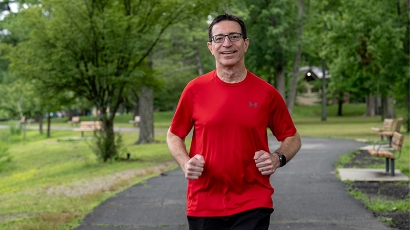 55-year-old Glen Rock resident, Steve Bermack, jogs down a cement path.