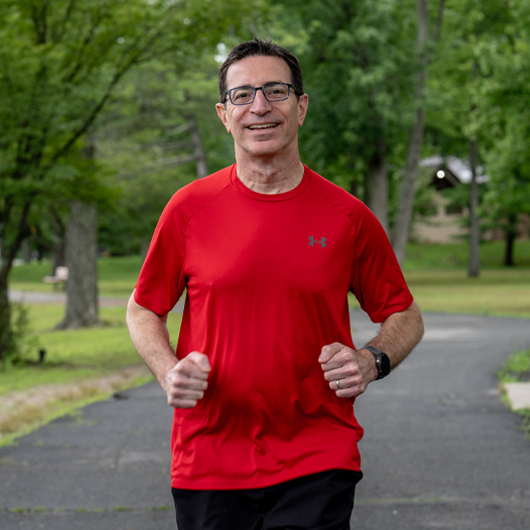55-year-old Glen Rock resident, Steve Bermack, jogs down a cement path.