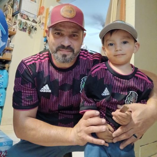 Jose Oliveres Estrade, 50, of Perth Amboy, New Jersey, poses next to a family member.