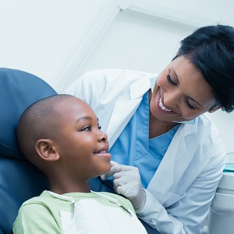 dentist examining a child's smile