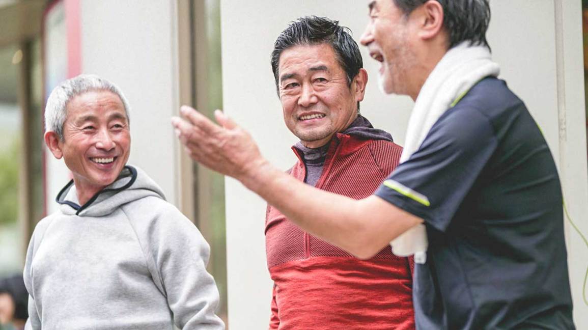 Three older men laughing