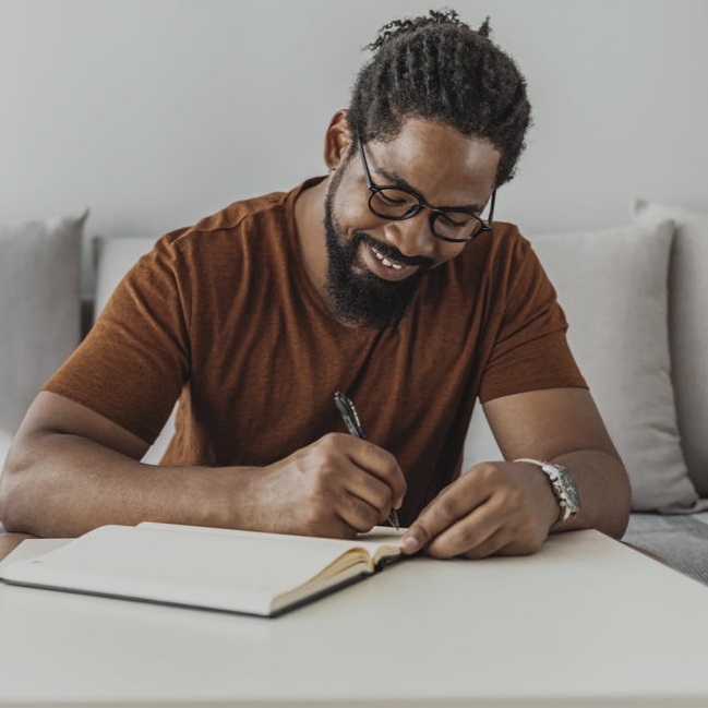 Man writes in notebook