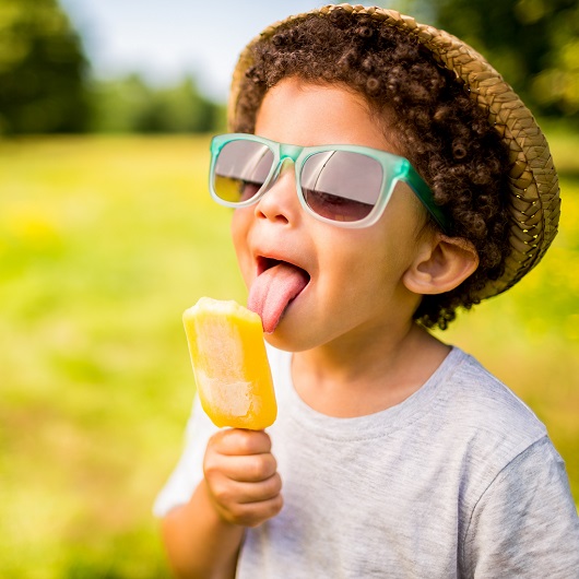 Young Boy Licking Popsicle Enjoying Summer