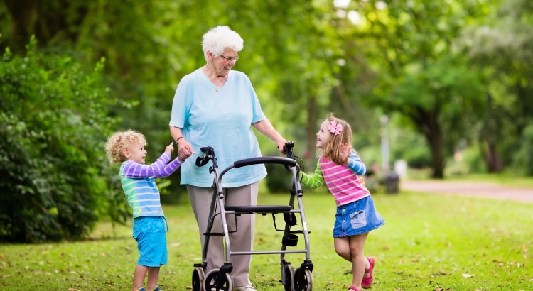 older woman using walker and young kids on either side