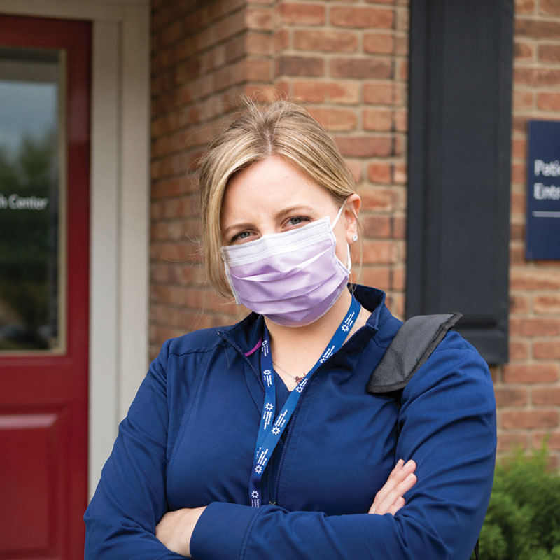 Home caregiver standing outside a patients house