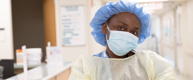 Nurse in mask and hospital gown