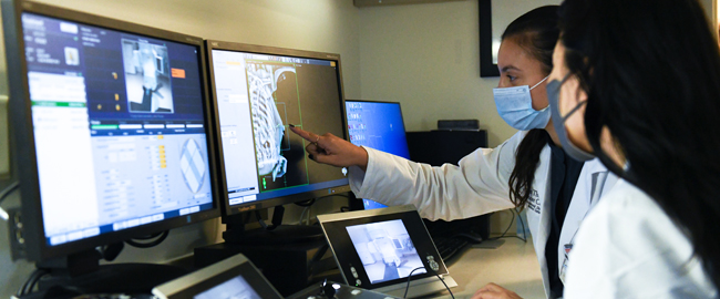 Two medical professionals review medical images