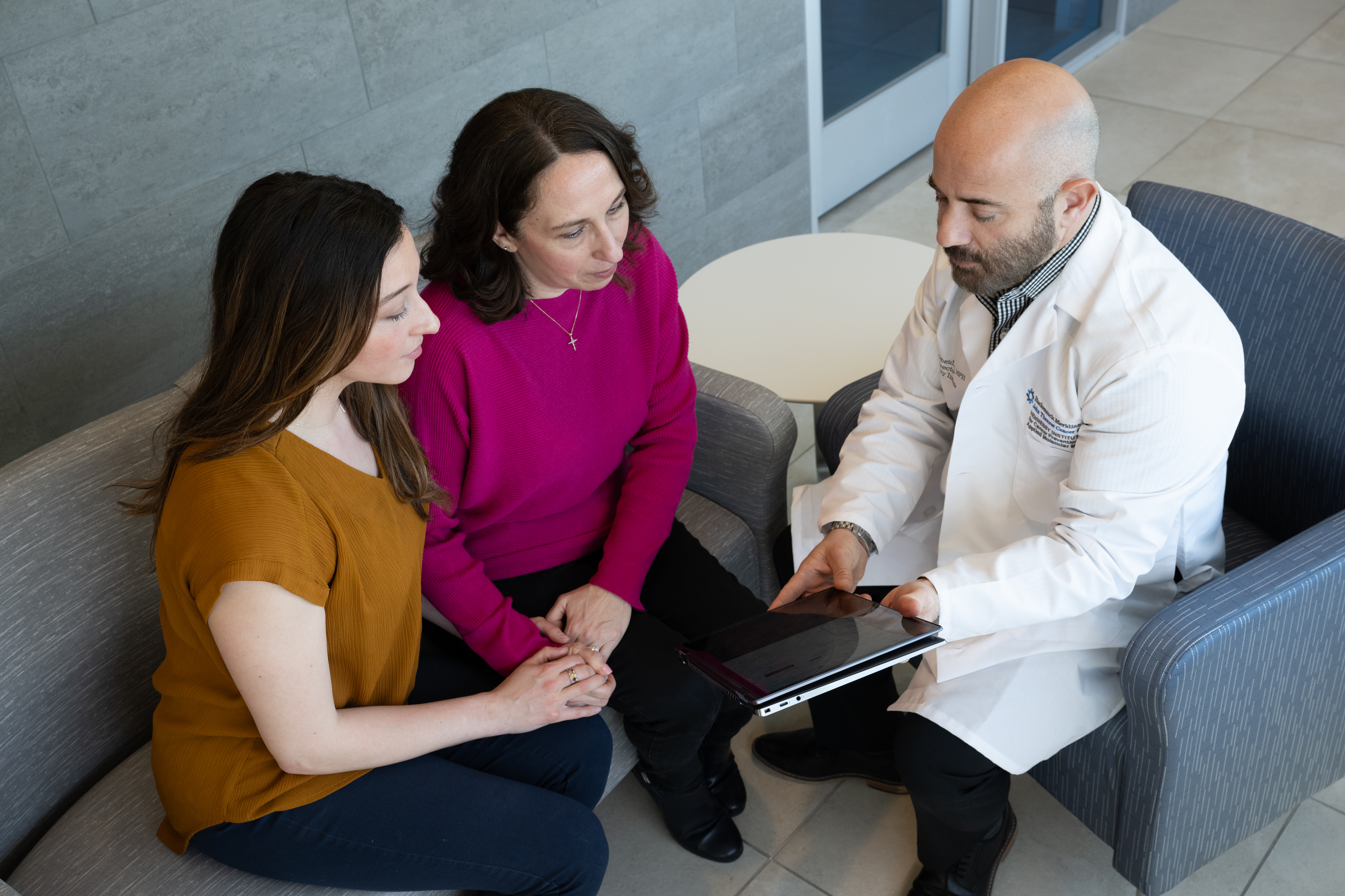 Doctor speaking with patient and family member