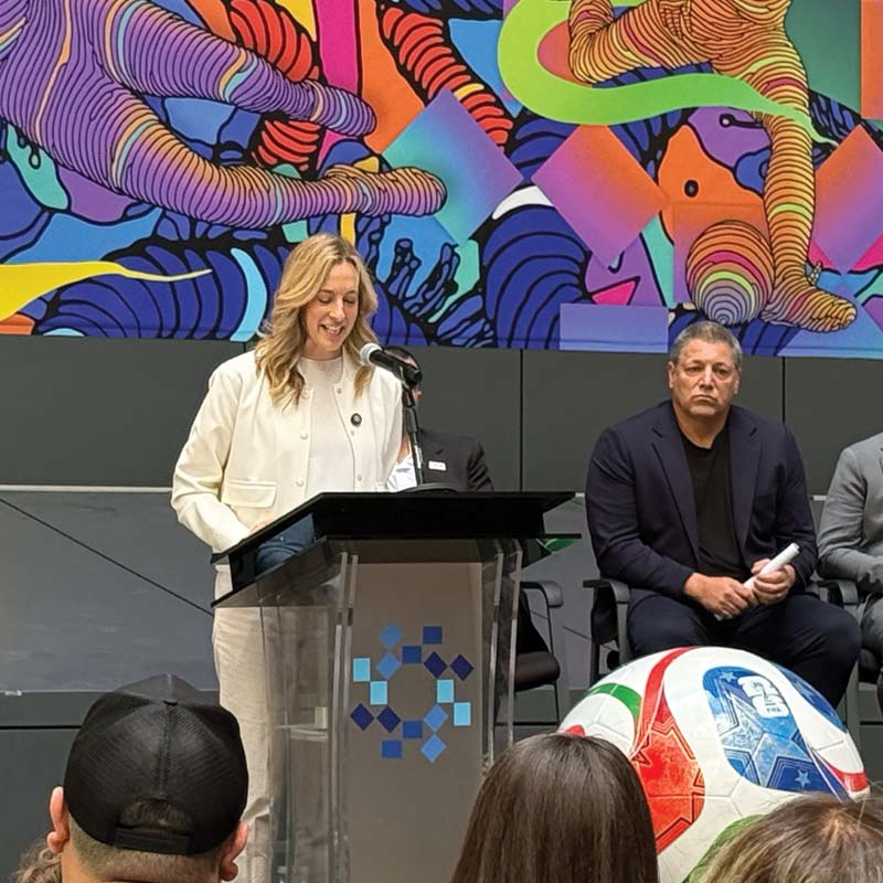 Speaker at podium during World Cup supporter event