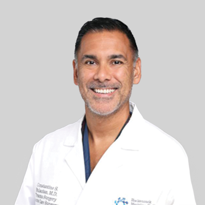 Man in white lab coat smiling
