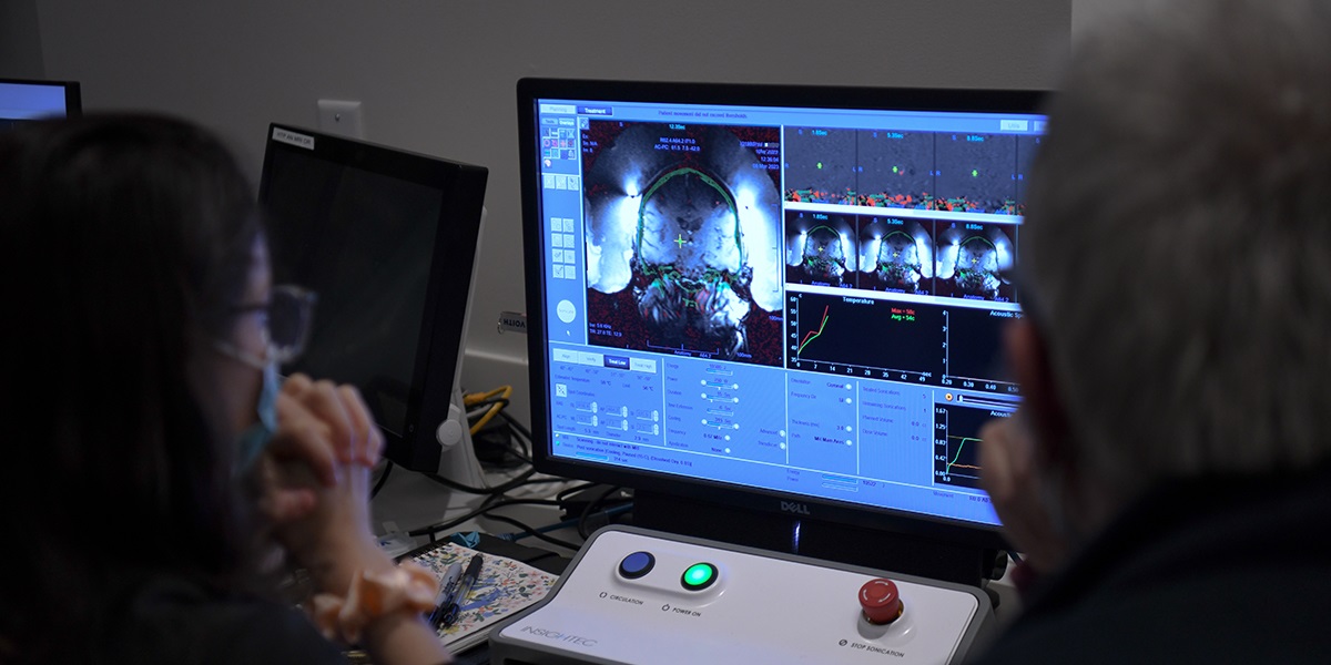 two physicians looking at a scan