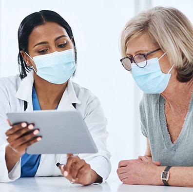 woman patient and woman provider looking at an i-Pad