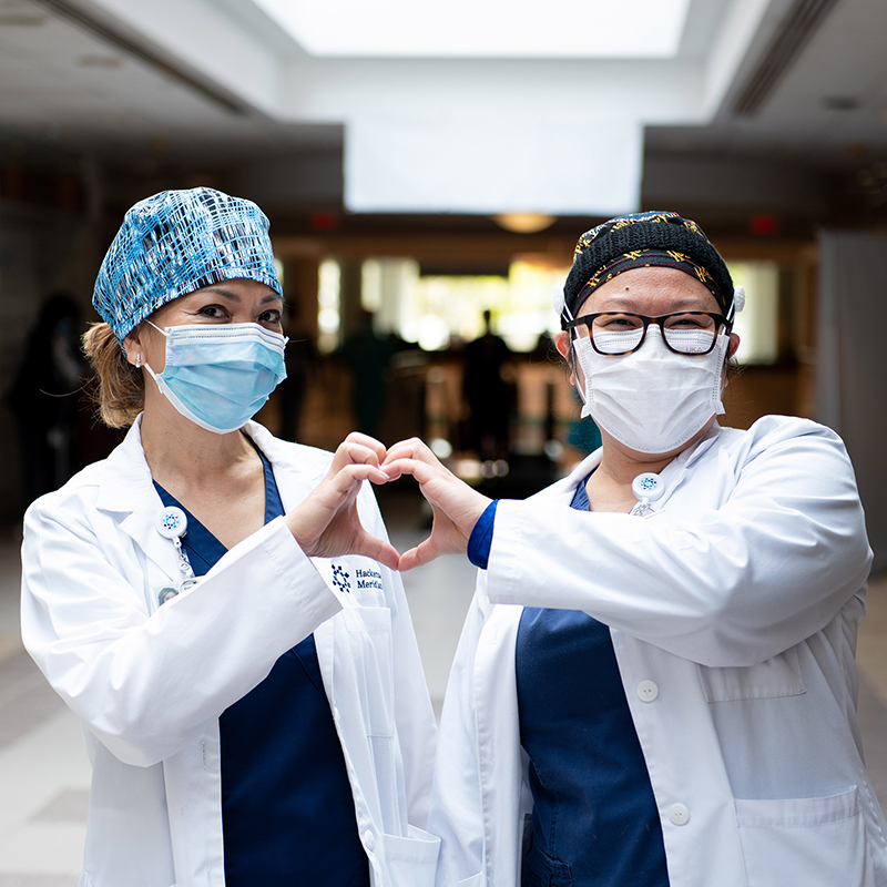 Nurse making heart hands photo