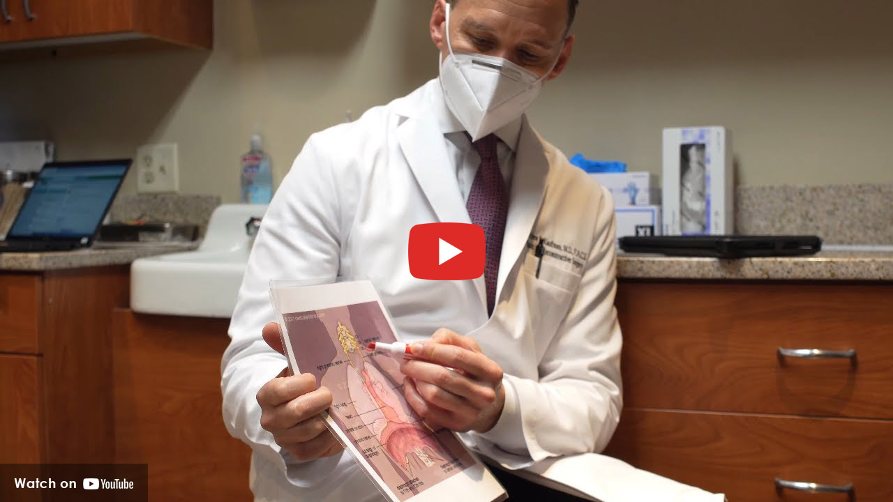Doctor with mask pointing at diagram of spine