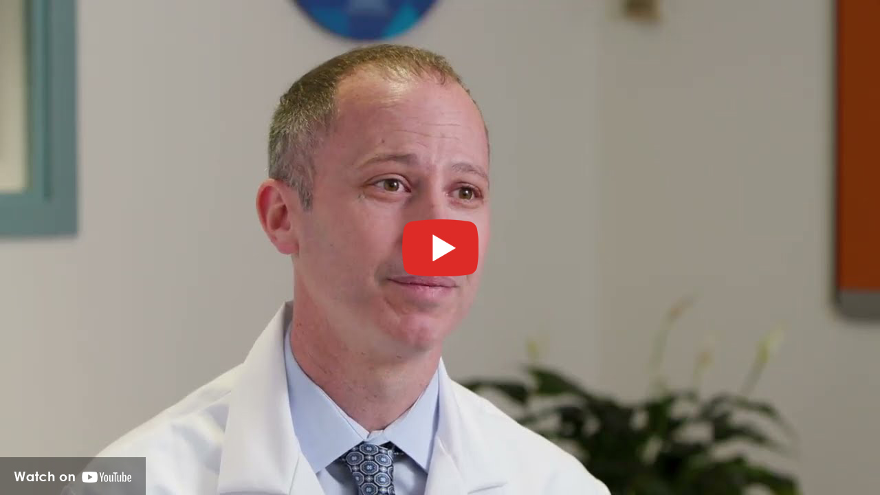 Doctor sitting in lab coat talking to patient