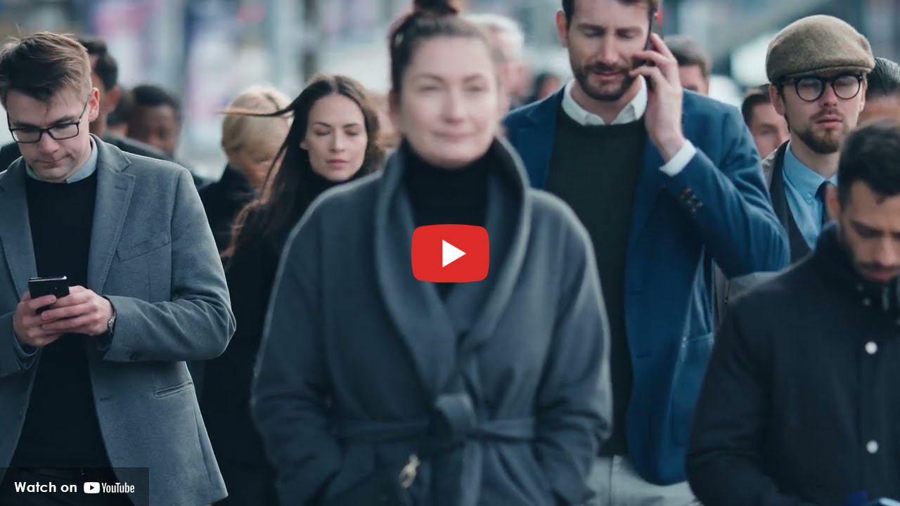 Crowd walking in city, people distracted on phones, illustrating hidden human trafficking