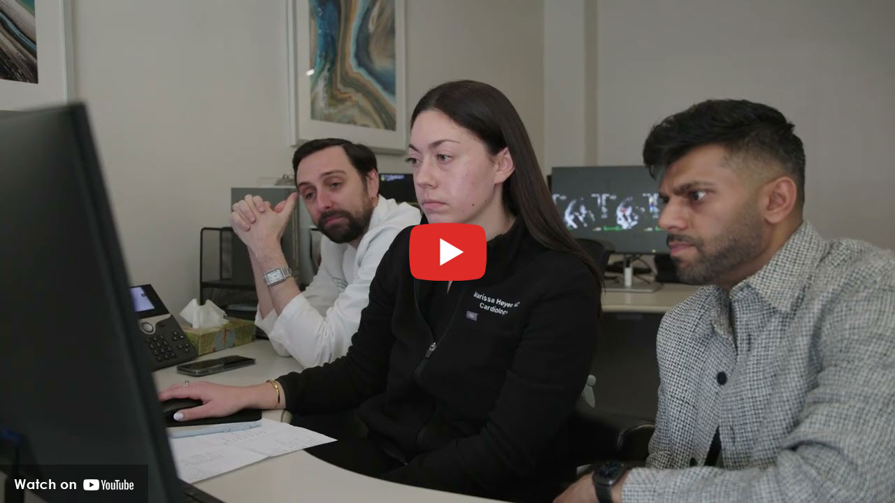 HUMC Cardiovascular Disease fellows looking at a computer screen together.