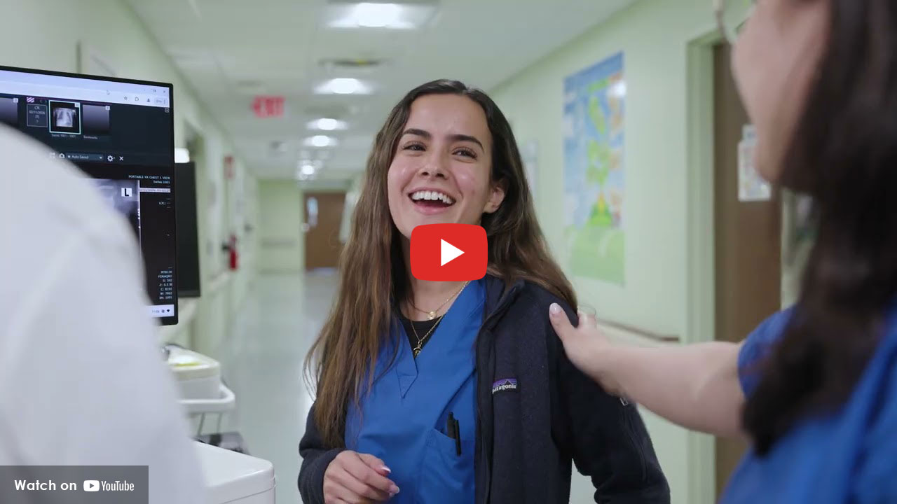 HUMC Pediatric NICU clinical team member smiling at co-workier.