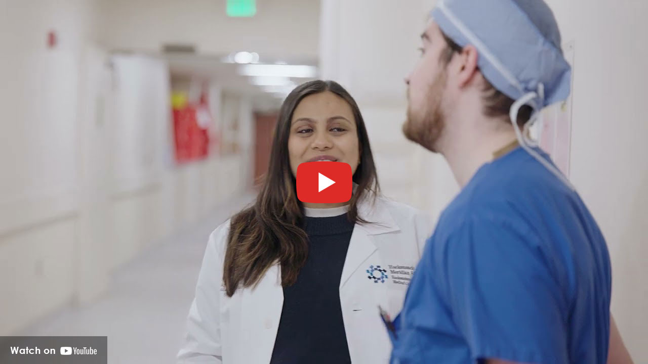 Two physicians having a conversation in the hallway.