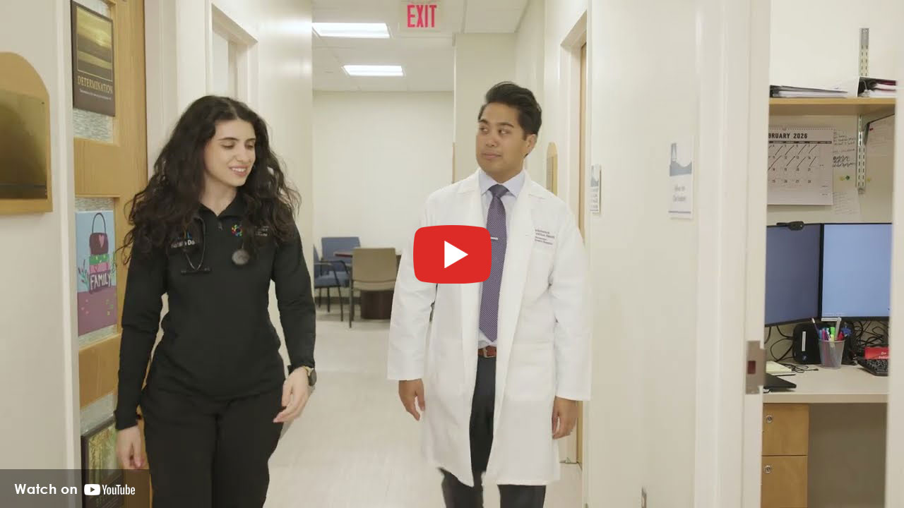 two physicians walking in hospital hallway