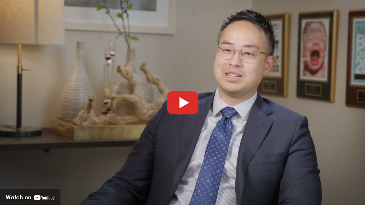 Doctor in a suit speaking during an interview in an office setting