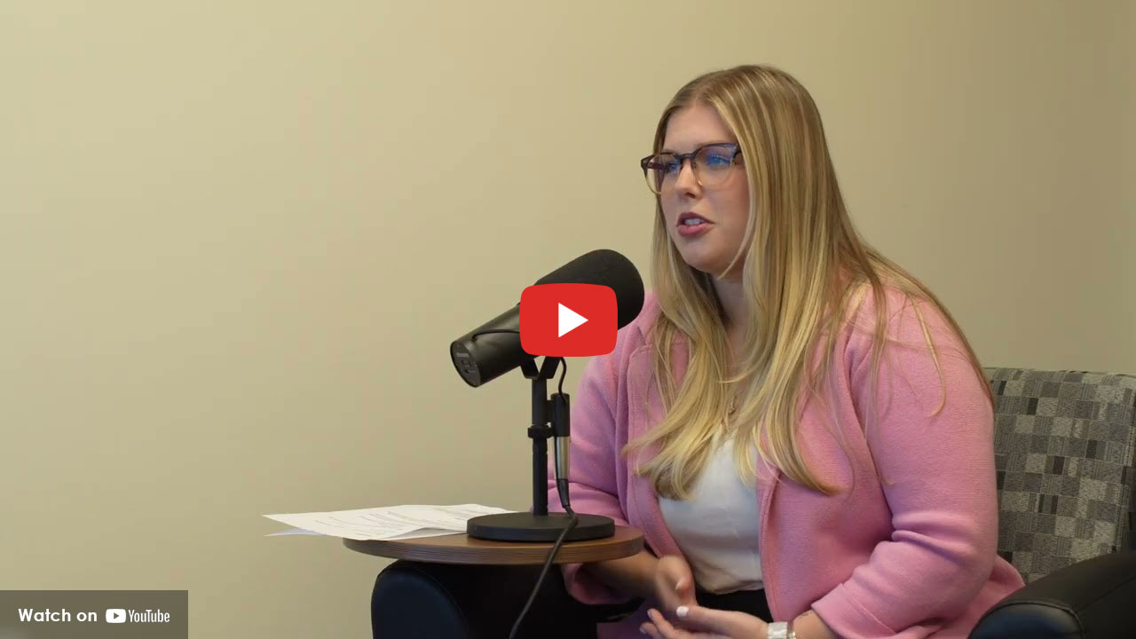 Woman speaking into a microphone during a health interview