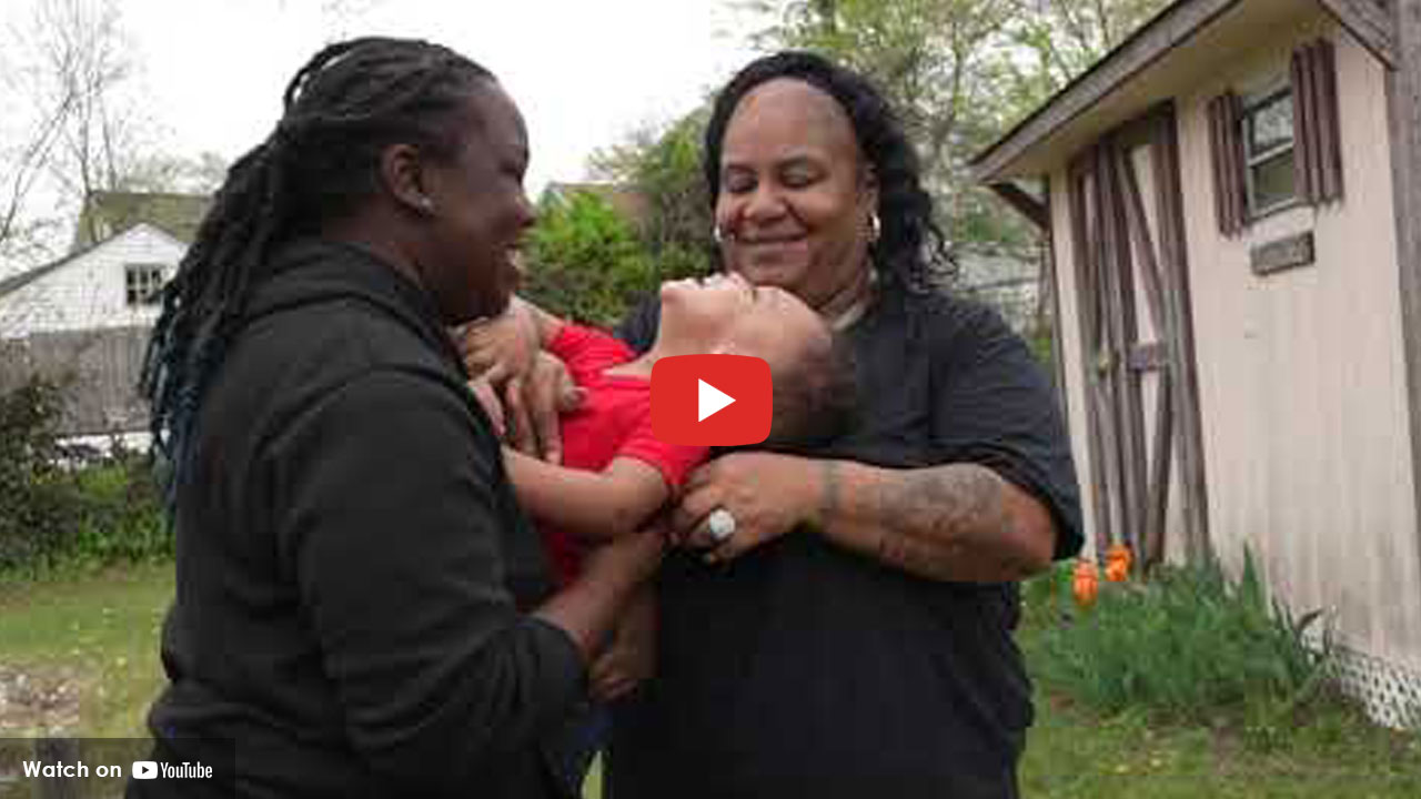 man and women holding small child
