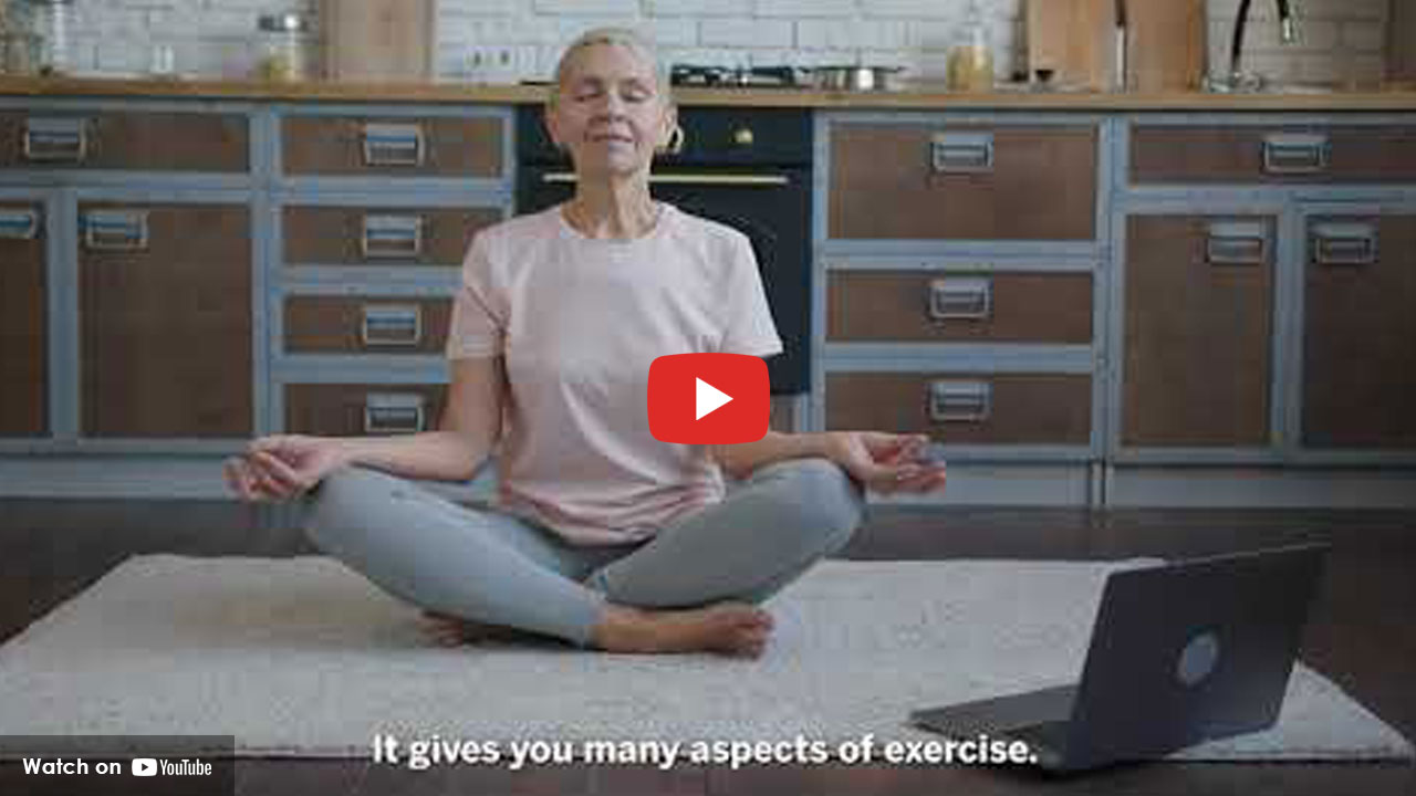 women sitting in yoga pose on the floor