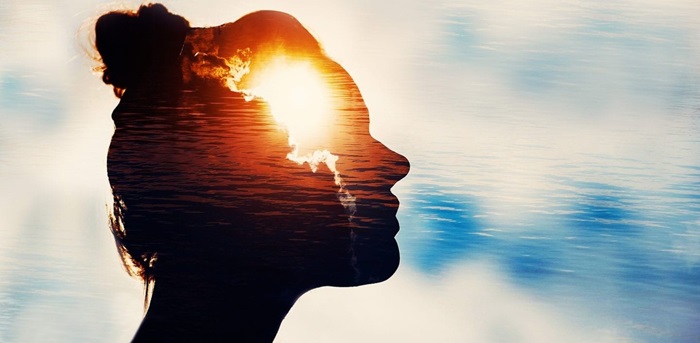 Woman's profile silhouette with a sun overlaid on her forehead