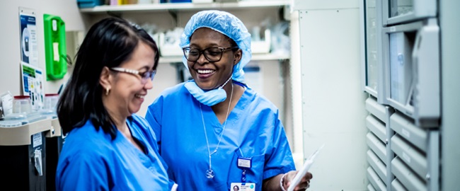 Two female nurses talking and smiling