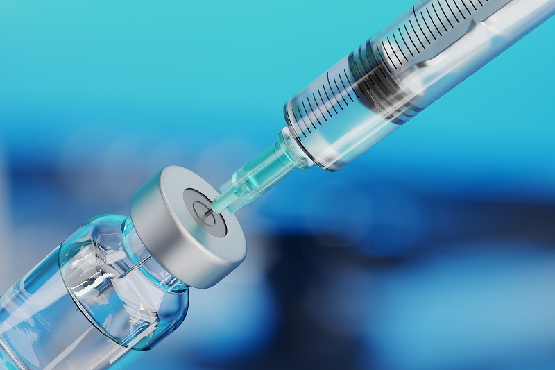 Close up of a syringe drawing a vaccine