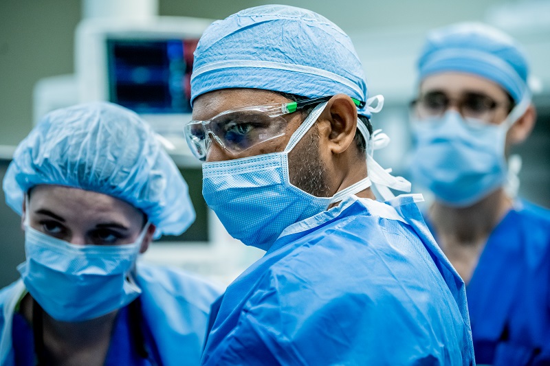 Physicians in the operating room preparing for heart surgery.
