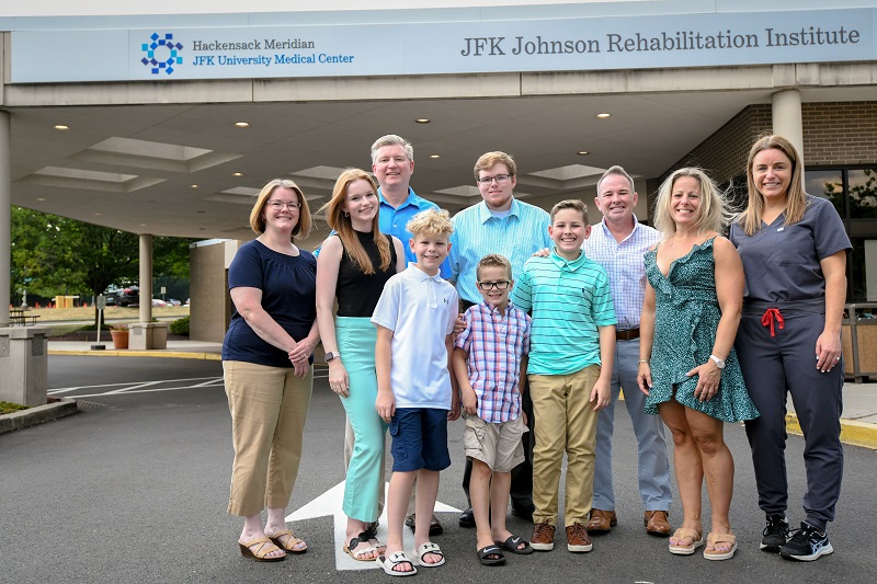 The Rydarowski family standing outside of JFK Johnson Rehabilitation Institute 