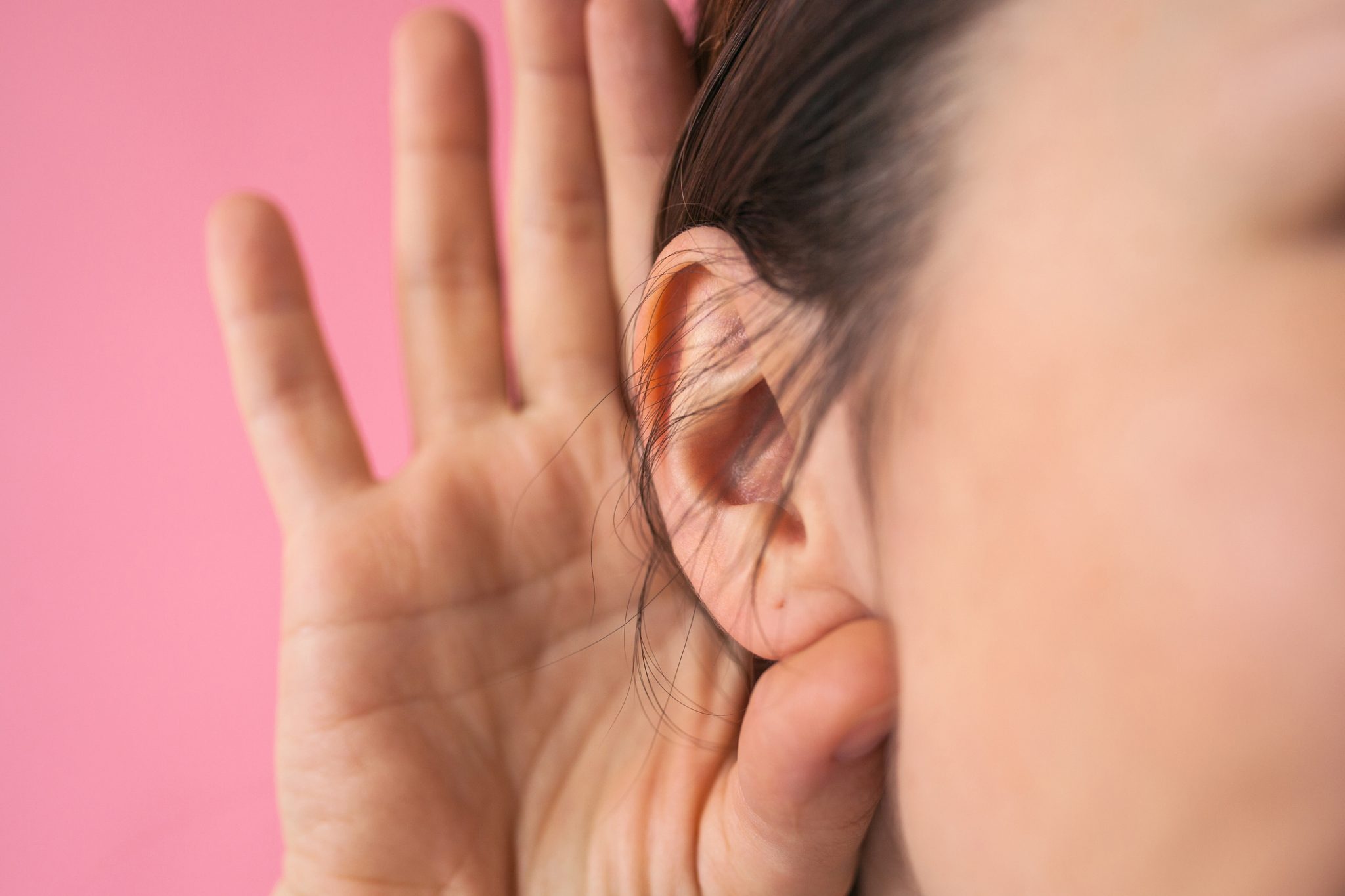 Woman gesturing for hearing